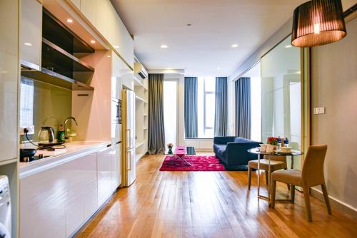 a kitchen and living room with a table and a couch at Flixses Suites at Platinum KLCC in Kuala Lumpur