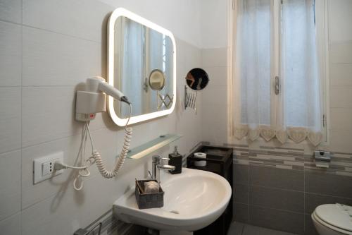 a white bathroom with a sink and a mirror at Country Resort Modena in Modena