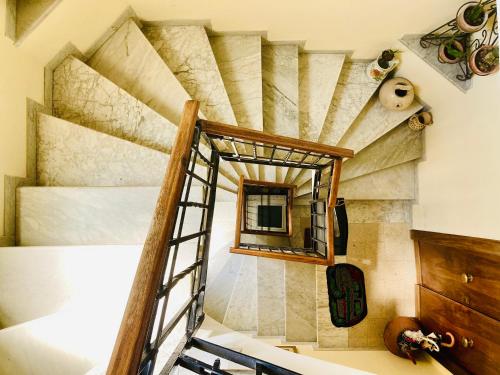 a room with a spiral staircase and a mirror at La Casetta di San Giovanni in Rome