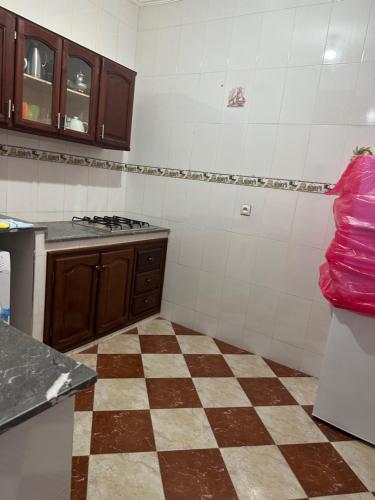 a kitchen with a checkered floor at GHIZLAN apartment TETOUAN in Tétouan
