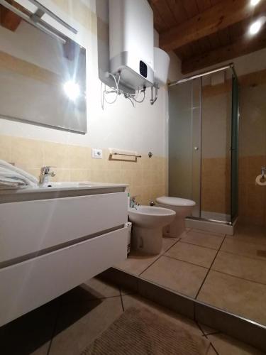 a bathroom with a sink and a toilet and a shower at Domus plano de laczarulo Acciaroli in Acciaroli