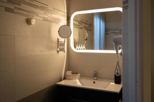 a bathroom with a sink and a mirror at Country Resort Modena in Modena