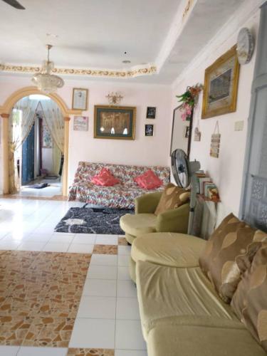 a living room with two couches and a couch at Love homestay CT in Kangar