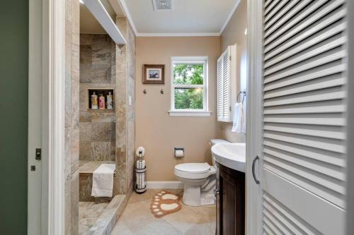 a bathroom with a toilet and a sink and a shower at Woodlands Vacation Home in Little Elm/ Frisco TX in Little Elm
