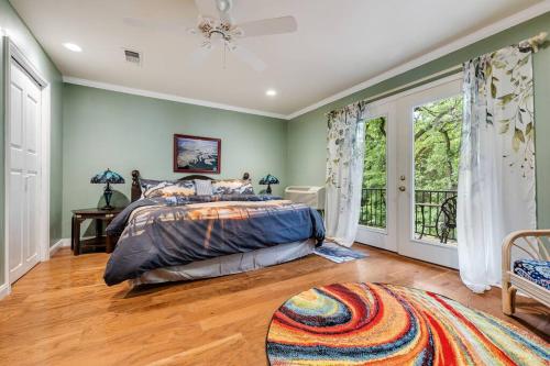 a bedroom with green walls and a bed and a window at Woodlands Vacation Home in Little Elm/ Frisco TX in Little Elm