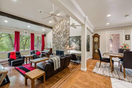a living room filled with furniture and a stone wall at Woodlands Vacation Home in Little Elm/ Frisco TX in Little Elm