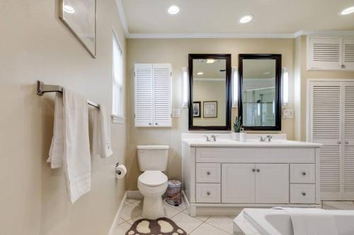 a bathroom with a toilet and a sink and a mirror at Woodlands Vacation Home in Little Elm/ Frisco TX in Little Elm