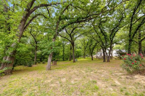 a park with trees and a bench and flowers at Woodlands Vacation Home in Little Elm/ Frisco TX in Little Elm