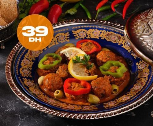 a plate of food with meatballs and peppers on it at Meknès adrae in Meknès