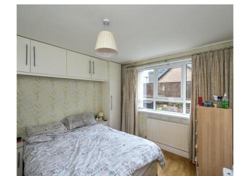 a bedroom with a bed and a large window at Beech Park in Deysbrook