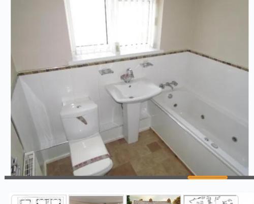 a bathroom with a sink and a toilet and a tub at Beech Park in Deysbrook