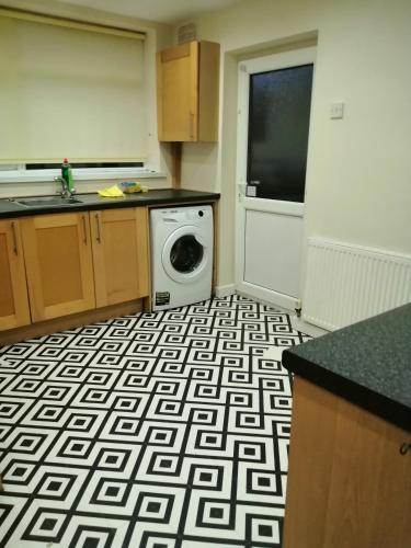 a kitchen with a black and white patterned floor at Beech Park in Deysbrook