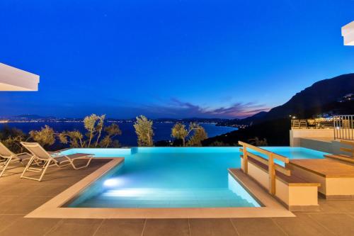 a swimming pool in the middle of a house at night at Villa Ble in Katávolos