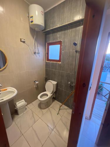a bathroom with a toilet and a sink at Tree House Dahab in Dahab