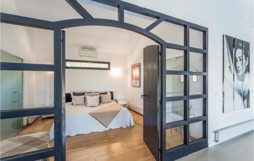 a room with a bed and a large glass door at Amazing Home In Ador With Kitchenette in Ador