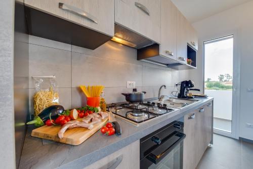 a kitchen with a counter with vegetables on a cutting board at !!! 2 MIN DALLA SPIAGGIA !!! - Casa Bentivegna in Sciacca