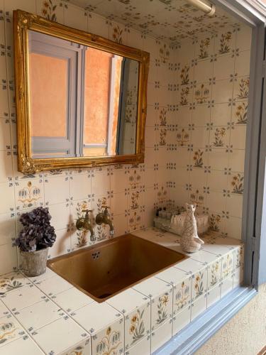 a bathroom with a sink and a mirror at Hotel de la Sologne in Beaugency