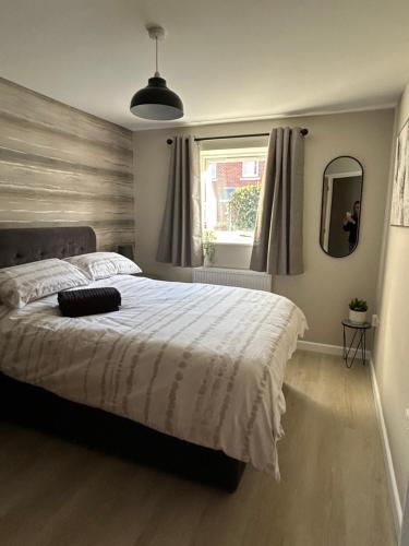 a bedroom with a large bed and a window at Chapel Court Apartments in Cannock