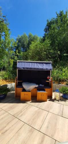 a bed sitting on top of a wooden deck at Am alten Deich in Sande