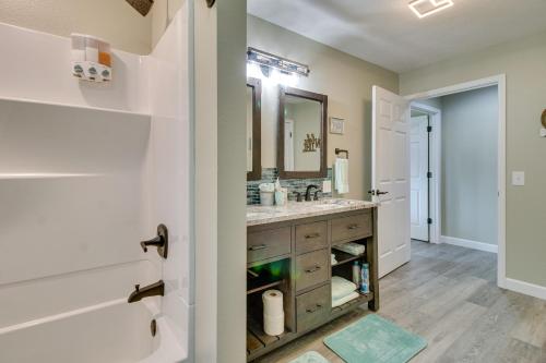 a bathroom with a sink and a mirror at Serene Lakefront Mountain Home Getaway with Atrium! in Mountain Home
