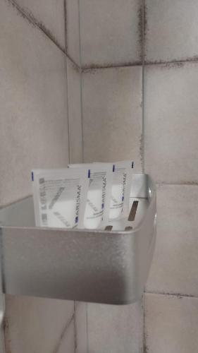 a toilet bowl with two pieces of paper in it at Casa Elvezia Guest House in SantʼElpidio a Mare