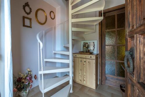 a spiral staircase in a home with a window at Guest House Sklithro in Sklíthron