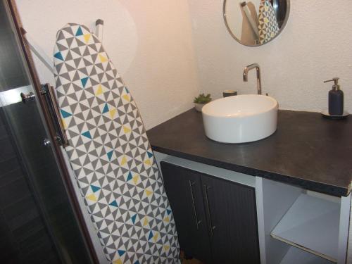 La salle de bains est pourvue d'un lavabo et d'un comptoir avec un miroir. dans l'établissement Studio sur le port, climatisation, wifi, piscine, lave-linge, à Gruissan