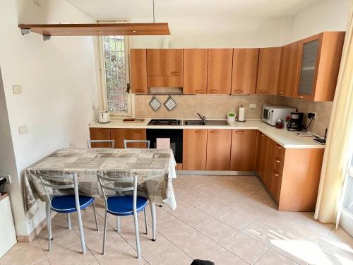 a kitchen with a table and chairs in a room at Apartment Bardolino lake front in Bardolino