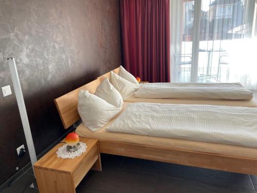 a bedroom with a bed with a wooden headboard at Hotel Restaurant Jura in Kerzers