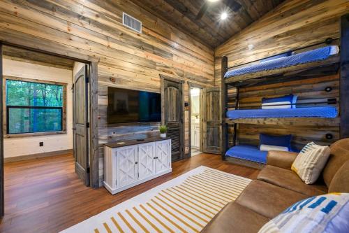 a bedroom with a bunk bed and a couch in a room at Brand New Luxury 2 Bedroom with Loft and Spa Sleeps 10 in Broken Bow
