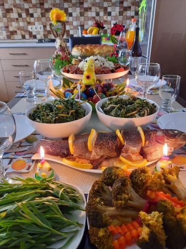 a table with plates of food on it with candles at Arevik BB in Chʼiva