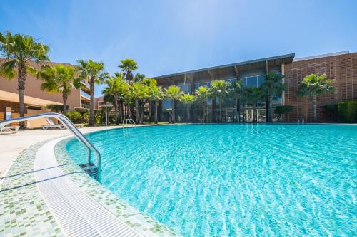 a large swimming pool in front of a building at Apartment Salgados by Algarve Vacation in Albufeira
