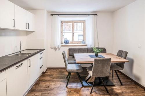 坎波迪特倫斯的住宿－Pfitscherhof，厨房以及带木桌和椅子的用餐室。