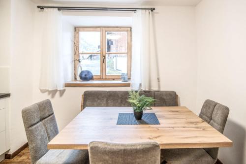 a dining room with a wooden table and chairs at Pfitscherhof in Campo di Trens