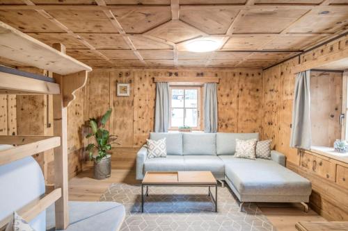 a living room with a couch and a table at Pfitscherhof in Campo di Trens