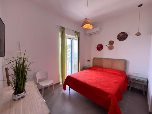 a bedroom with a red bed and a window at Thai Boutique rooms in Peschici