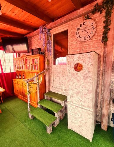 a room with stairs and a clock on the wall at LA CASA DEL SOLE in Merone