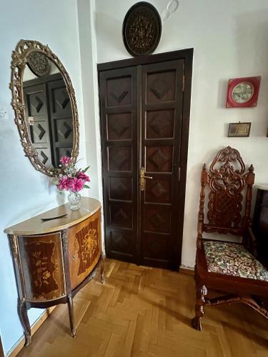 a room with a mirror and a table and a chair at Vintage-style 2 bedroom apartment at Katechaki in Athens