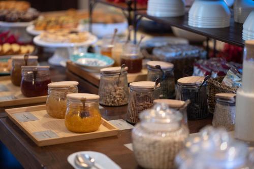 a table with jars of food and other food items at Hotel Villa Favorita in Noto