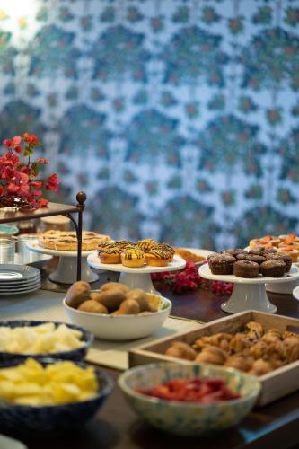 a table filled with different types of food on plates at Hotel Villa Favorita in Noto