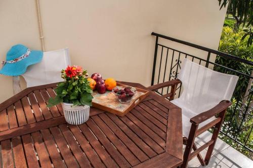 a wooden table with a bowl of fruit on a balcony at Phyllida Guest House - M4 in Zacharo