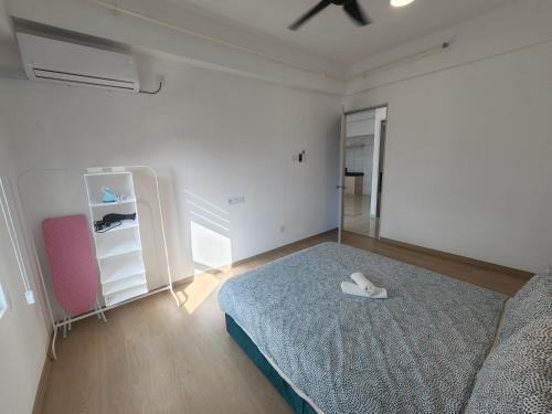 a white bedroom with a bed and a mirror at Praicon Executive Suite in Butterworth