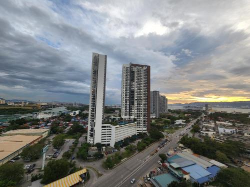 a city skyline with two tall buildings and a street at Praicon Executive Suite in Butterworth