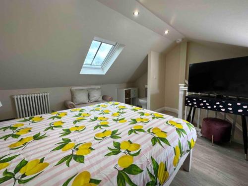 a bedroom with a large bed with yellow flowers on it at Impressive 3 bed cottage by the river in Stanhope in Stanhope