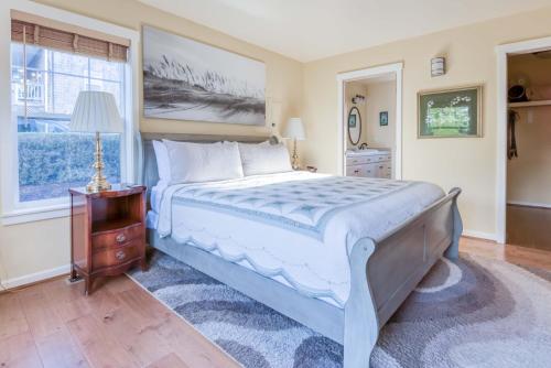 a bedroom with a large bed and a window at Driftwood at Roads End in Lincoln City