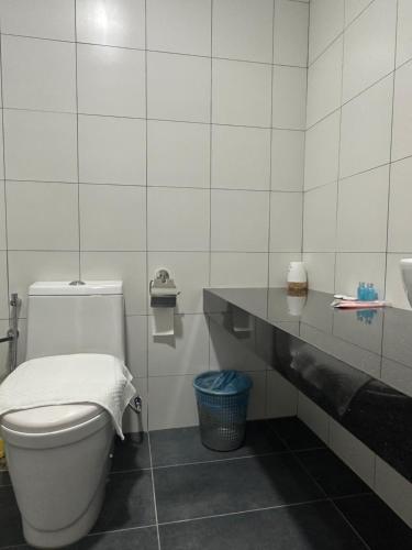 a bathroom with a toilet and a sink at Chambers Suites KL in Kuala Lumpur