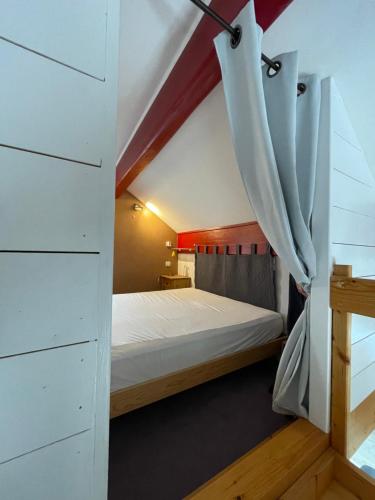 une petite chambre avec un lit dans un grenier dans l'établissement loft sur les montagnes, à Saint-Michel-de-Chaillol