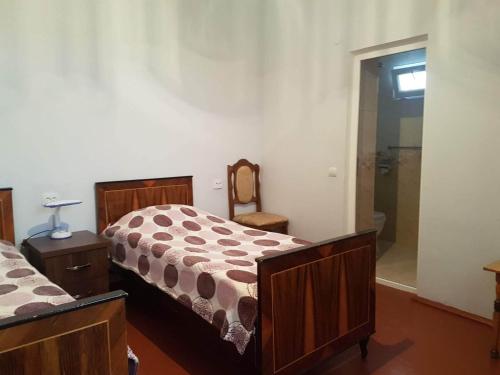 a bedroom with two beds and a walk in shower at Arevik BB in Chʼiva