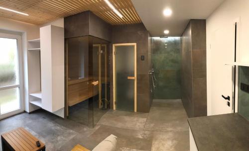 a bathroom with a shower and a glass door at Zlinapartman in Zlín