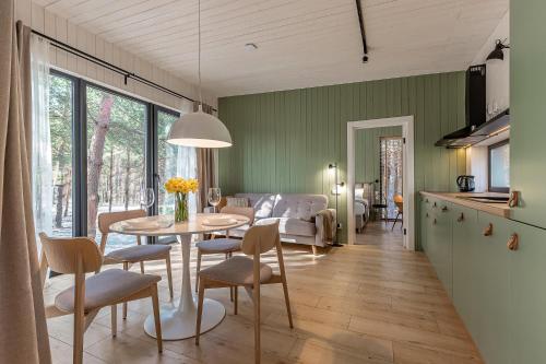 a kitchen and living room with a table and chairs at Заміський комплекс - DOGODA in Dzvinkove